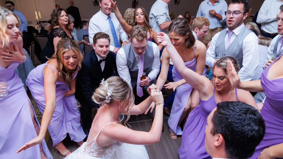 Wedding DJ performing live during reception showing concert-style energy