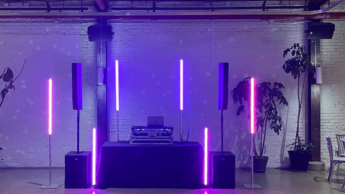Wedding DJ setup showing redundant speakers and backup wireless microphones before guests arrive